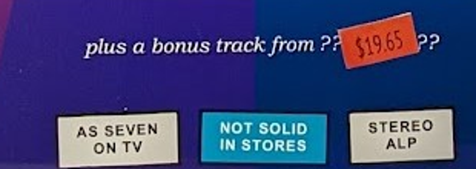 The bonus track line, hidden under the $19.65 sticker, and the three badges